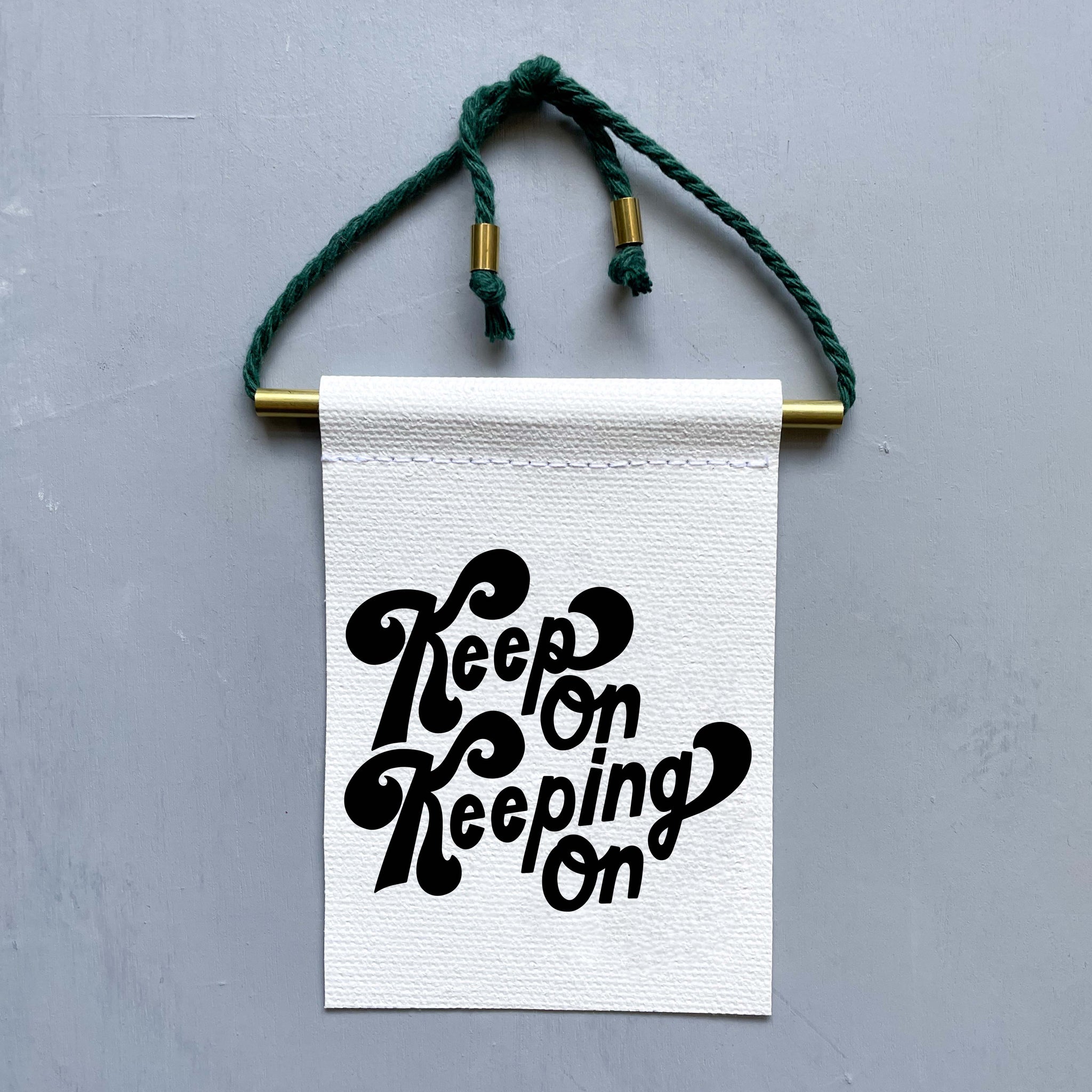 Keep On Keeping On Brass and String Hanging Banner